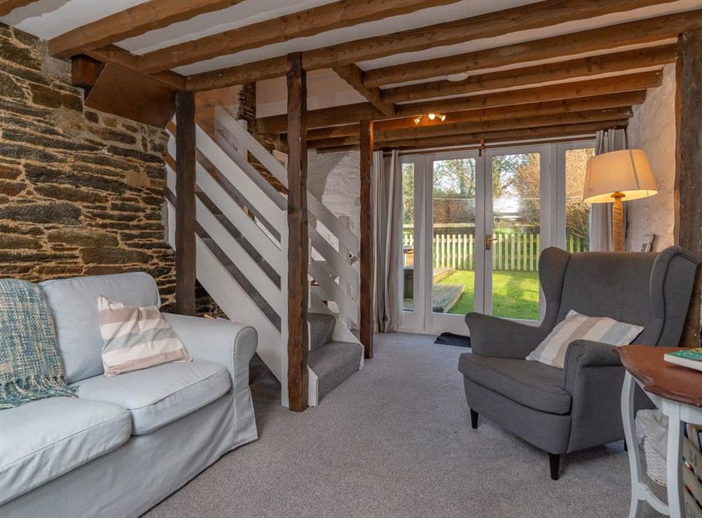 Characterful living area with French doors to garden at Dairy Cottage in Fowey, Cornwall