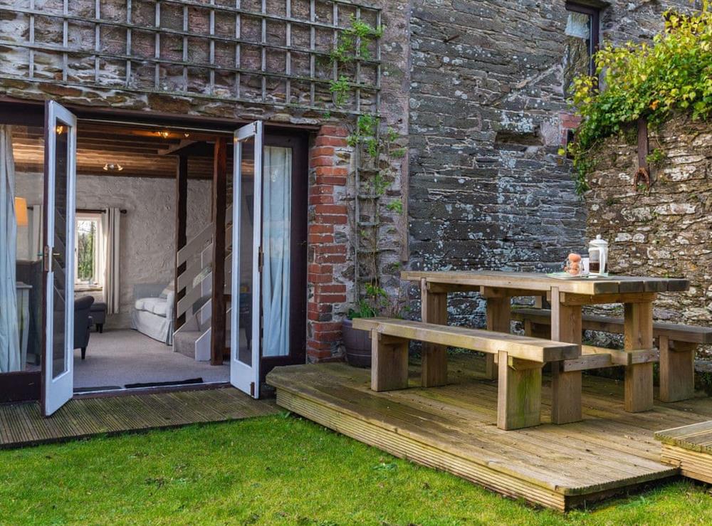 Decked patio with outdoor furniture at Dairy Cottage in Fowey, Cornwall