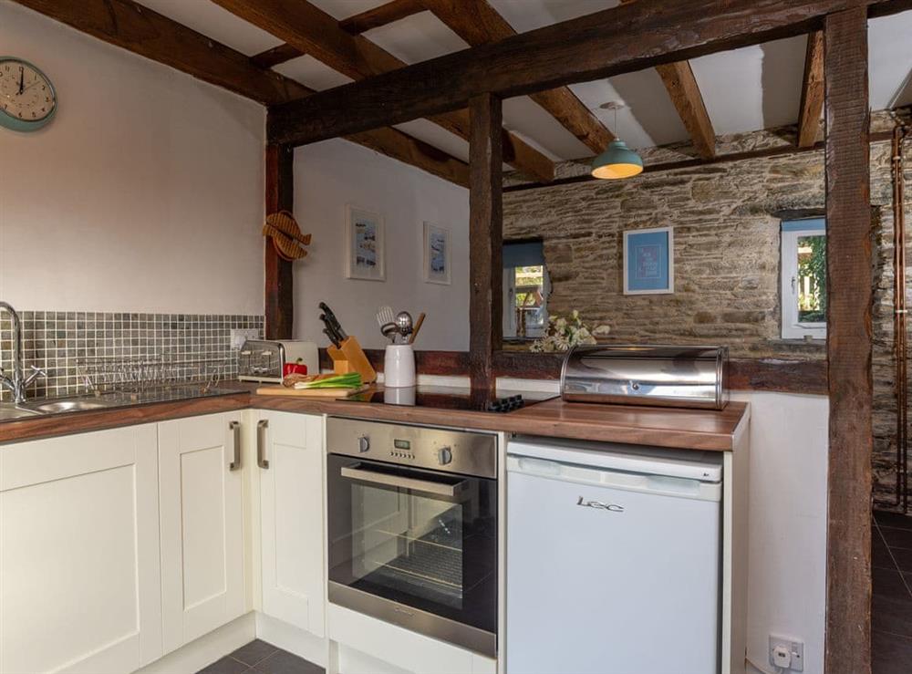 Well-equipped fitted kitchen at Dairy Cottage in Fowey, Cornwall