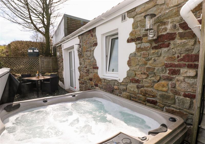 Relax in the hot tub at Dairy Cottage, Tavernspite near Whitland