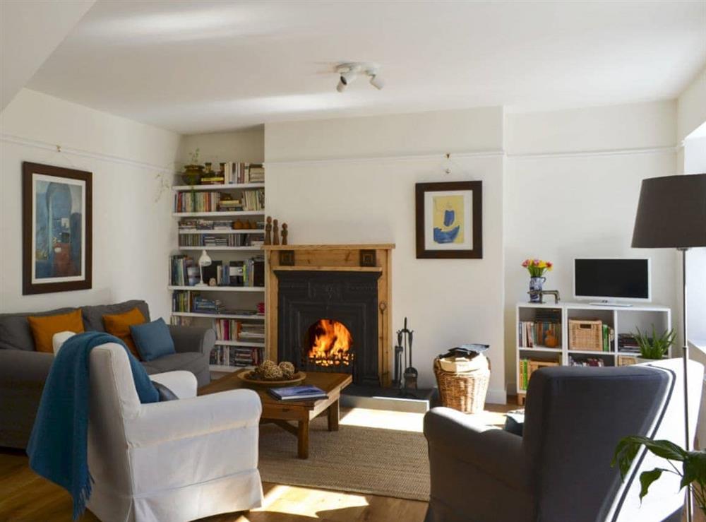 Living room with open fire at Dairy Cottage in Torlundy, Fort William, Inverness-Shire