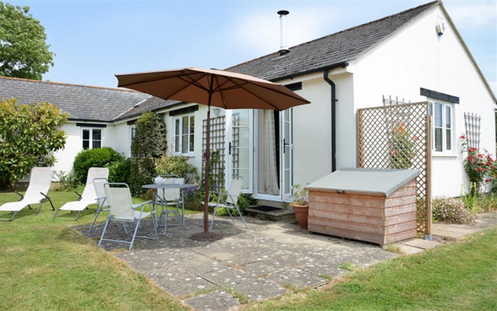 Use the patio area for relaxing or dining  at Dairy Cottage in Whitchurch Canonicorum