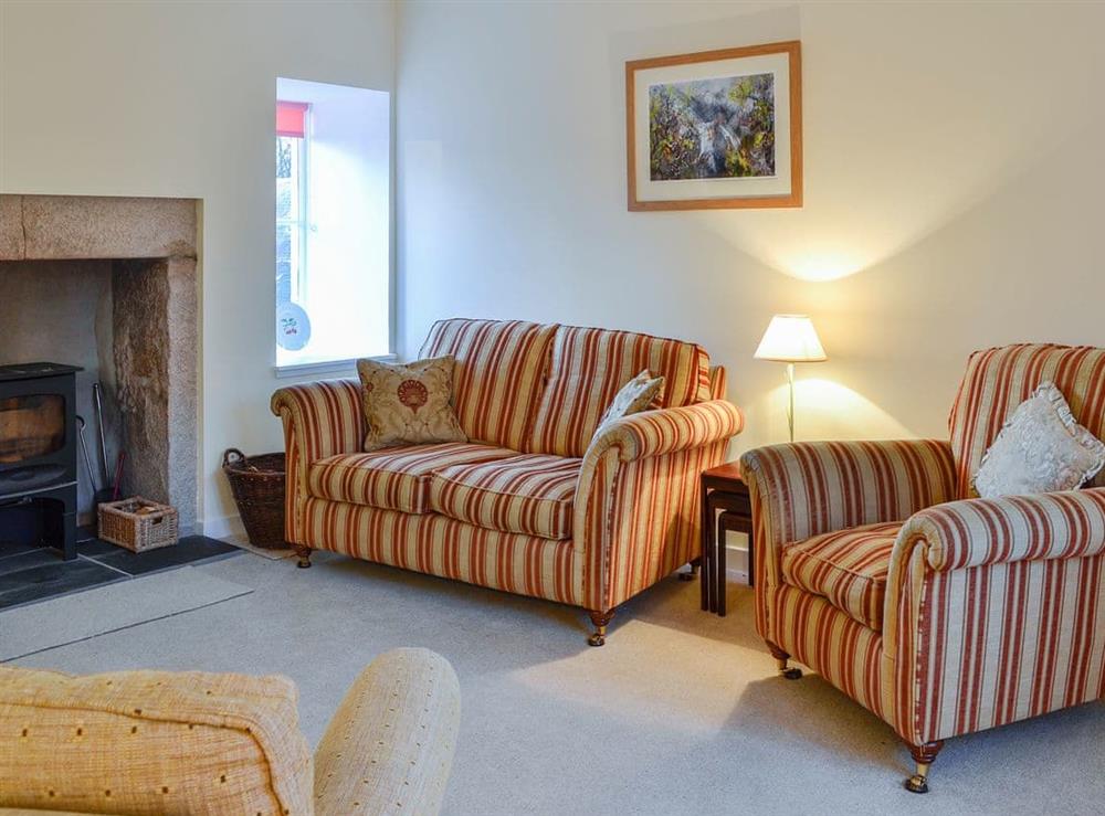 Comfortable living room with feature fireplace at Dairy Cottage in Whitehouse, near Alford, Aberdeenshire