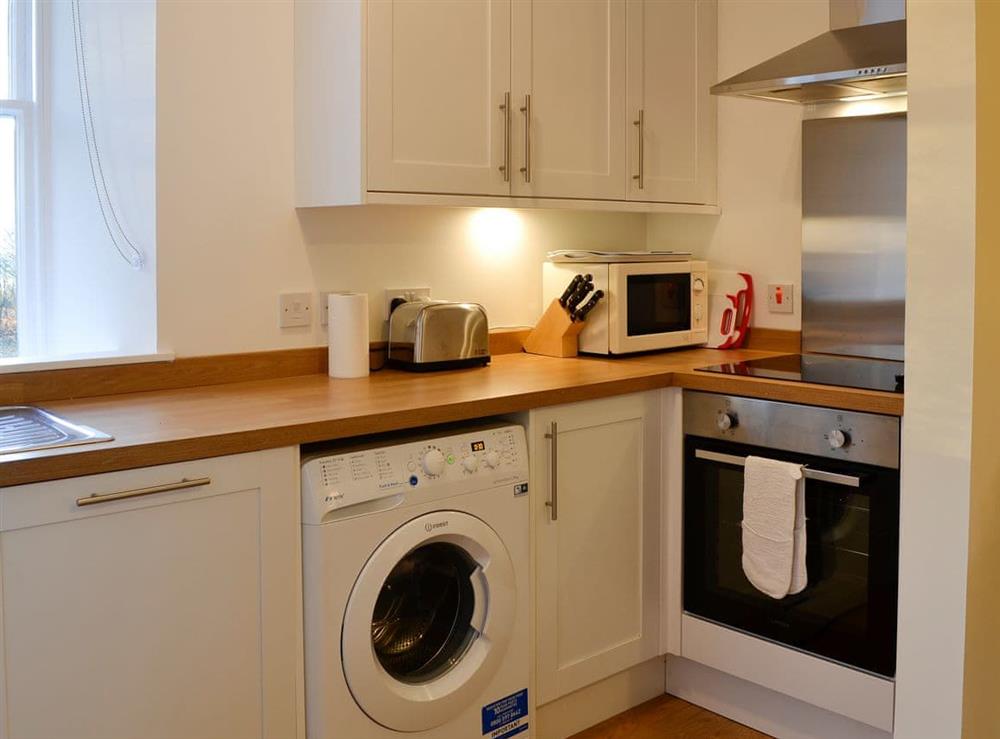 Kitchen with laundry facilities at Dairy Cottage in Whitehouse, near Alford, Aberdeenshire