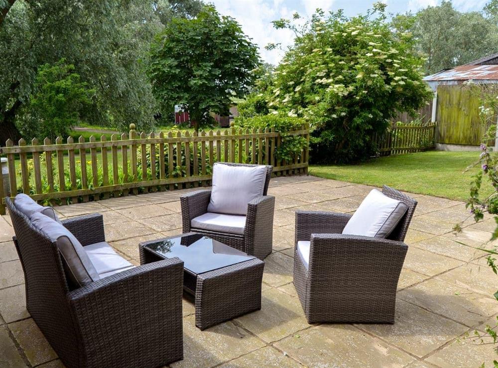 Patio with garden furniture at Dairy Farm Cottage in West Caister, Norfolk