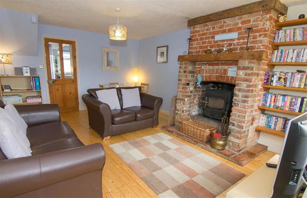 Daisy Cottage:  Sitting room with feature fire surround at Daisy Cottage, Northrepp near Cromer