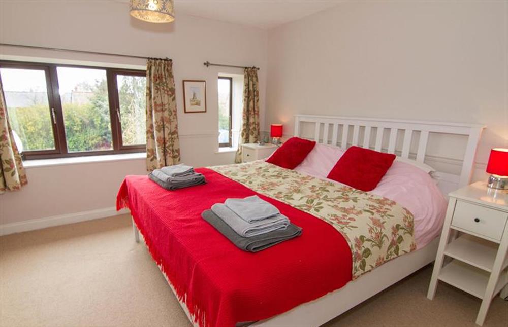 First floor:  Master bedroom with super king-size bed at Daisy Cottage, Northrepp near Cromer