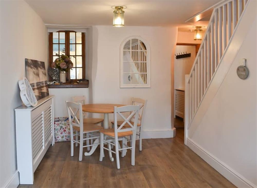 Dining area with stairs to first floor at Daisy Cottage in Shaldon, Devon