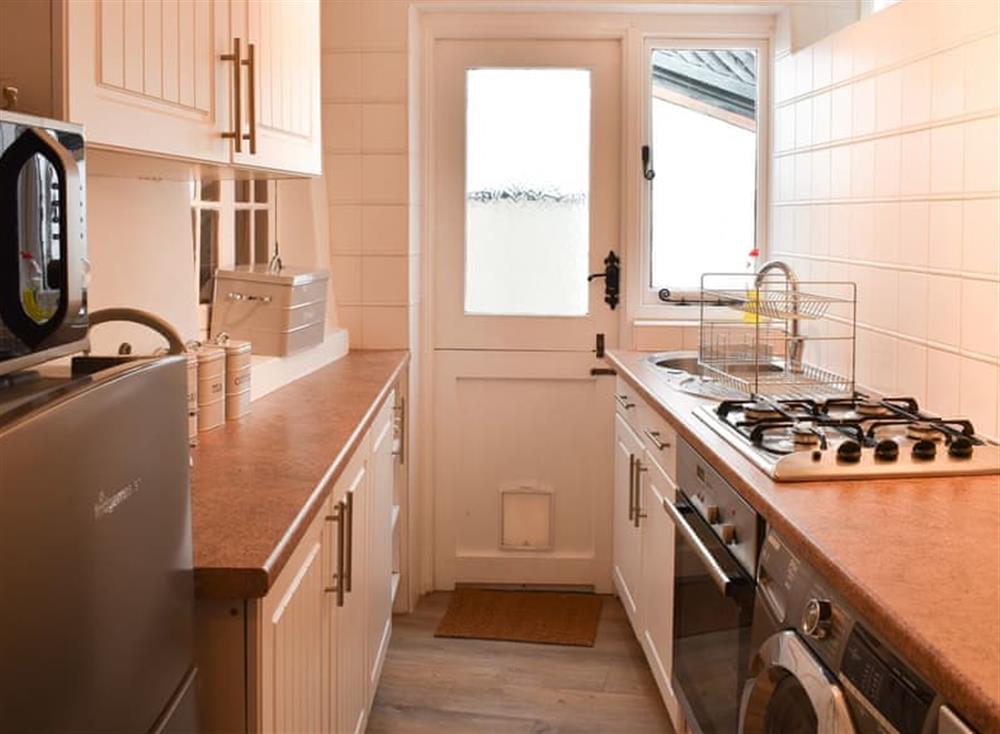 Well appointed kitchen with access to outdoor area at Daisy Cottage in Shaldon, Devon