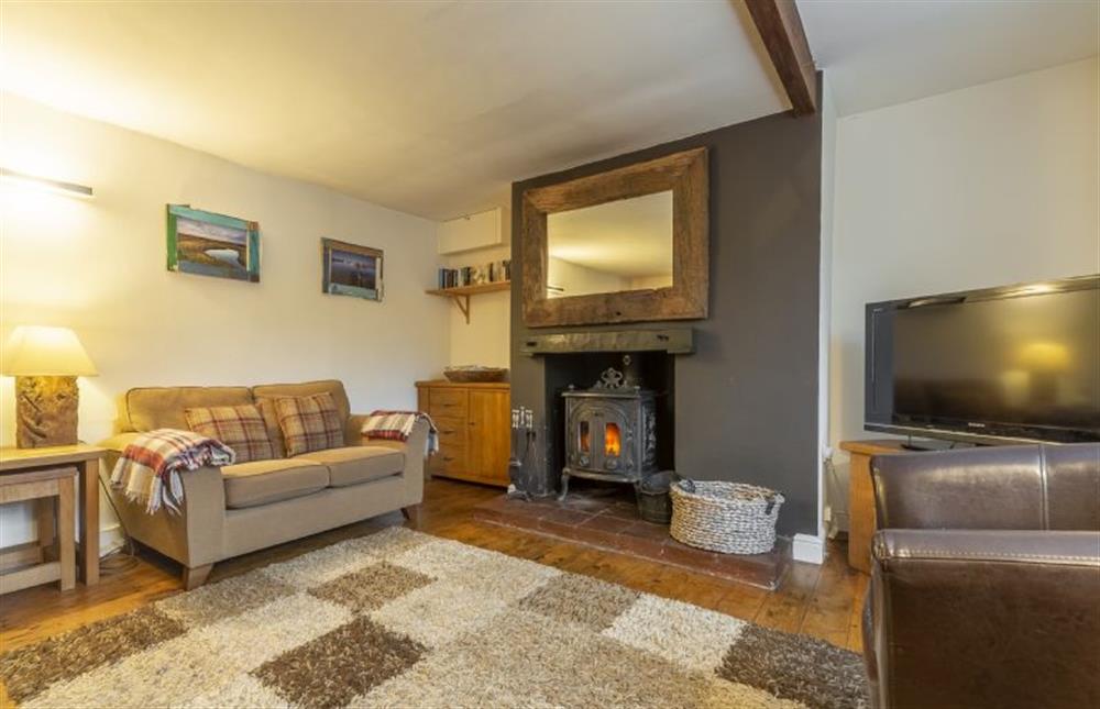 The sitting room has stylish wood burning stove at Daisys Cottage, Wells-next-the-Sea