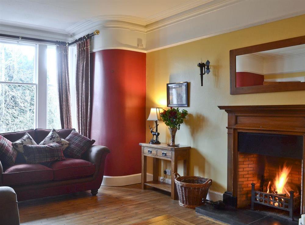 Large living room with open fire at Dallas Brae in Grantown-on-Spey, Morayshire