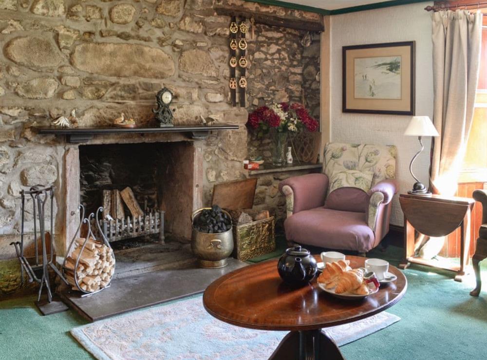 Characterful living room with an open fire at Dalvanie Mill in Blairgowrie, Perthshire