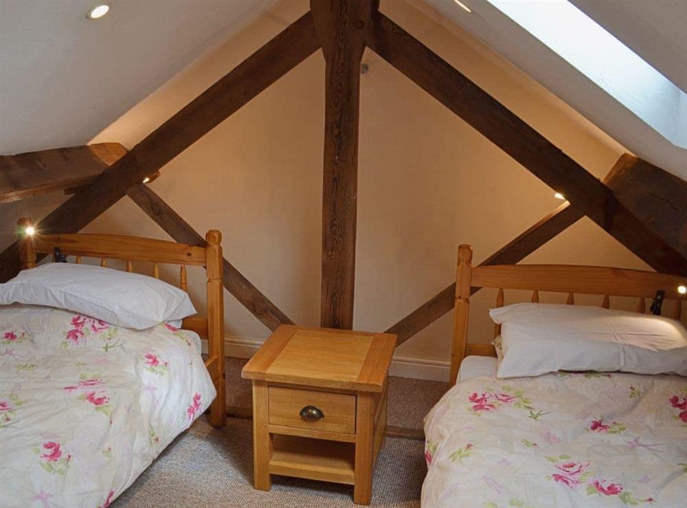 The twin bedroom is beamed with a vaulted ceiling at Damsels Bower in Over Haddon, near Bakewell, Derbyshire