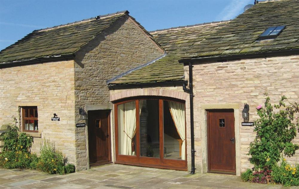 Damson Cottage is to the right of the full length window