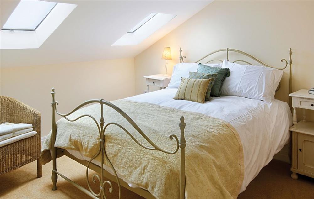 Master bedroom with 5’ bed and fully tiled en-suite shower room with wc and basin at Damson Cottage, Rainow