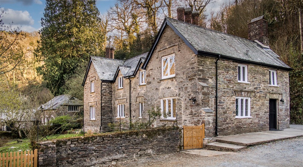The side and back of Millers House, a large slatestone cottage with grassy garden, Cornwall at Danescombe Cottage in Calstock, Cornwall