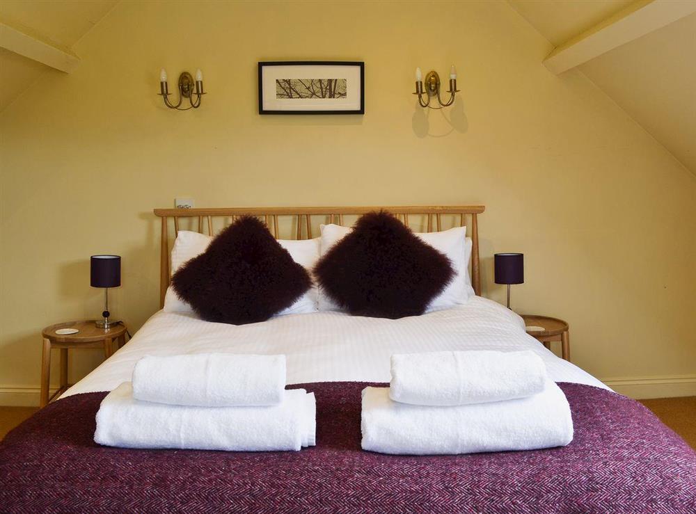 Bedroom with kingsize bed at Daneshurst Cottage in Tiptoe, near Lymington, Hampshire