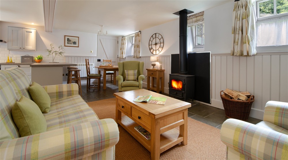 The open-plan room with sitting area, dining table and kitchen at Darfar in Nr Ashbourne, Derbyshire