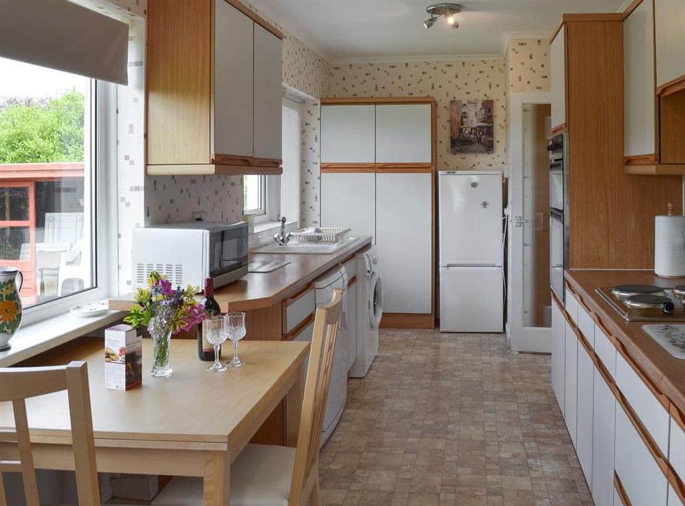 Breakfast area, electric oven and hob, microwave, kettle, fridge / freezer, dishwasher, washing machine and Freeview TV at Dart Corner in Bovey Tracey, Devon