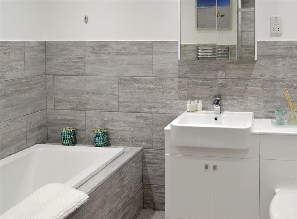 Bathroom with bath and separate shower cubicle at Deepwater Point Apartment  in Torquay, Devon