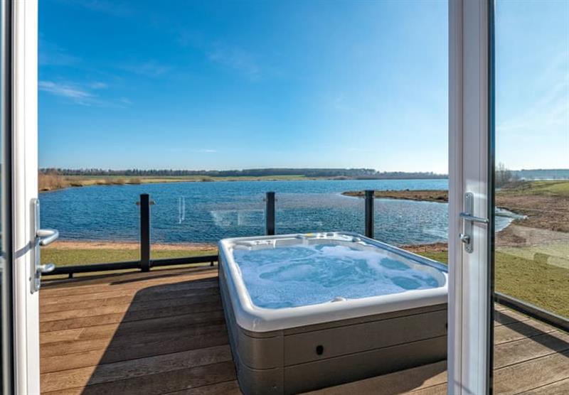 The hot tub on the veranda of the Country Lodge Eight VIP Platinum at Delamere Lake Holiday Park in Delamere Forest, Heart of England