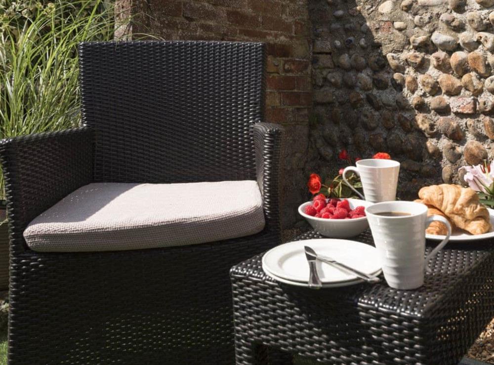 Charming sitting area with garden furniture at Dell Cottage in Mundesley, near North Walsham, Norfolk
