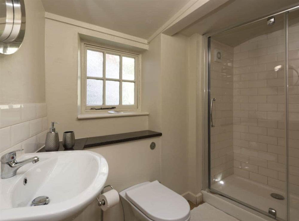 Shower room with shower cubicle and toilet at Dell Cottage in Mundesley, near North Walsham, Norfolk