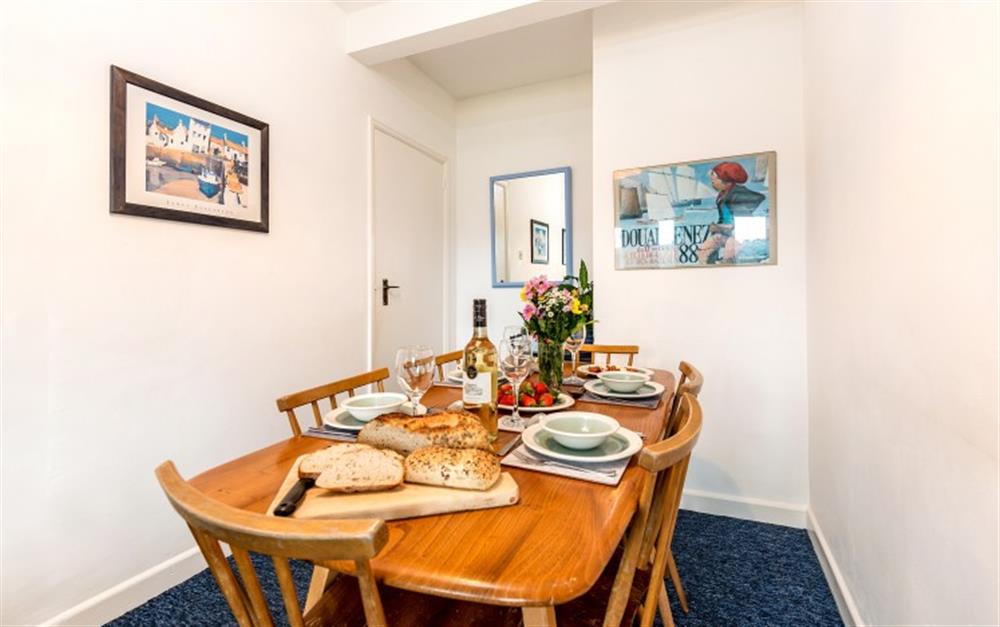 A cosy space for a family supper or an evening of family board games. at Demelza 1 in Helford Passage