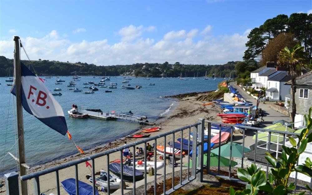 Pull up a chair and watch the world go by from the garden. at Demelza 1 in Helford Passage