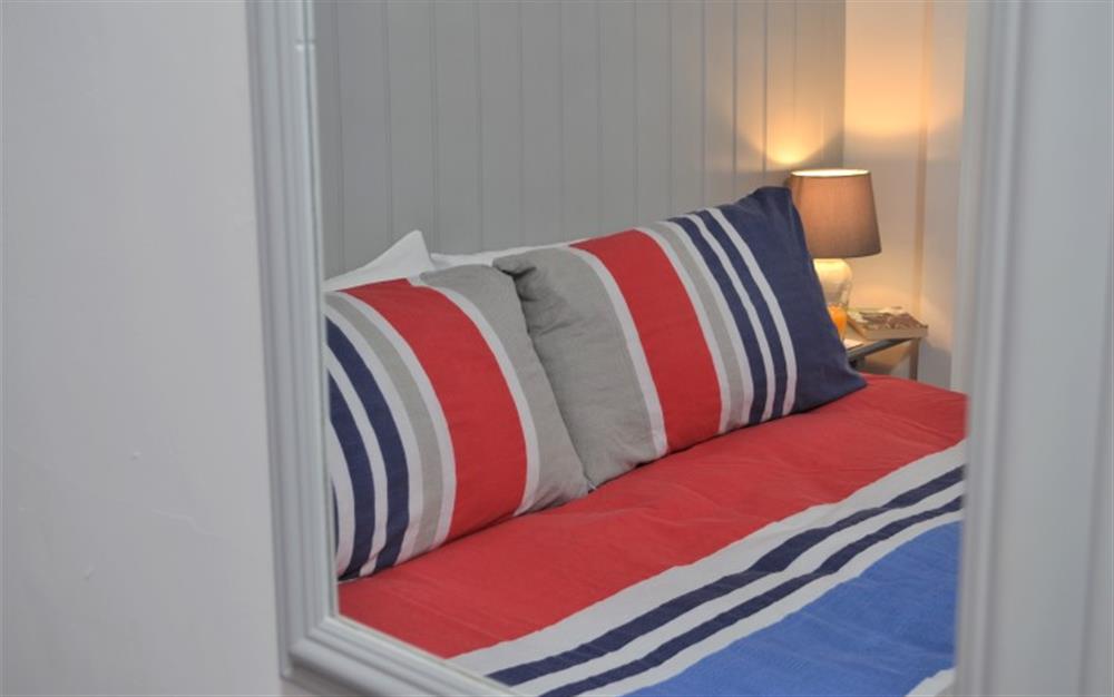 The bed linen gives a pop of colour to the pale coloured wall.