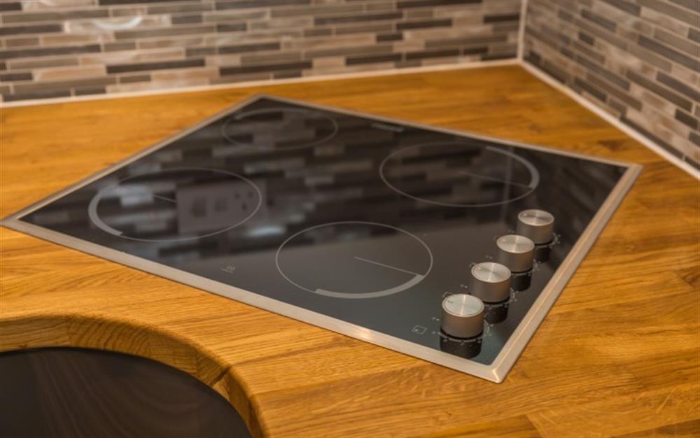 The wooden work surfaces look amazing against the charcoal grey units.