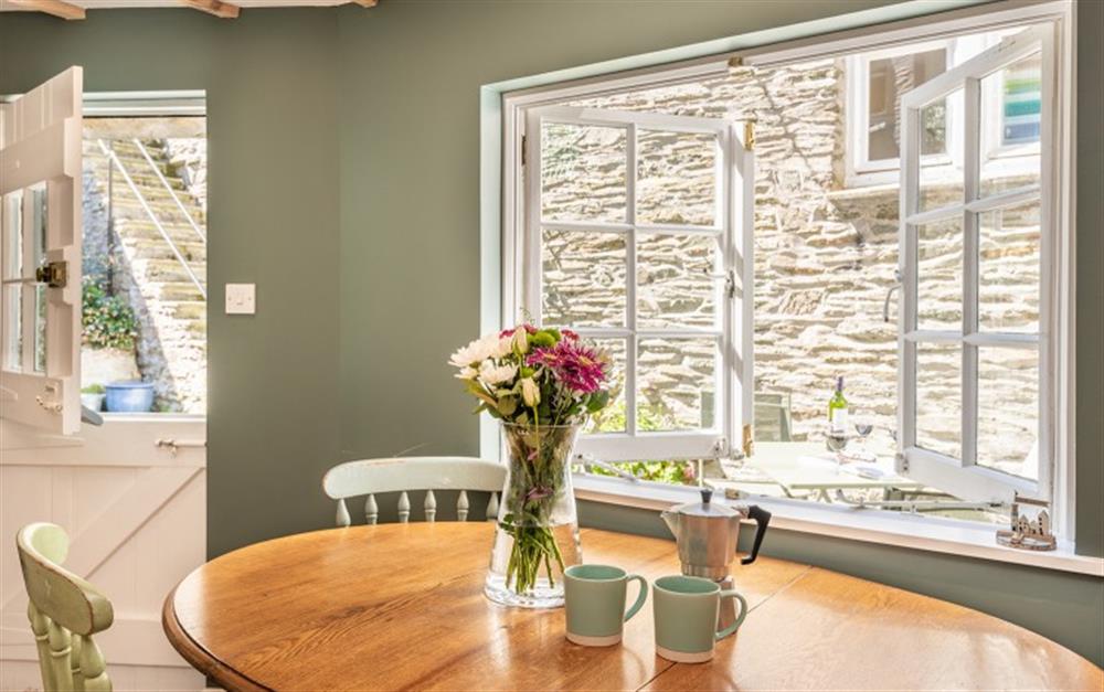 Bright dining area with view to the lovely courtyard at Dene Cottage in Polperro