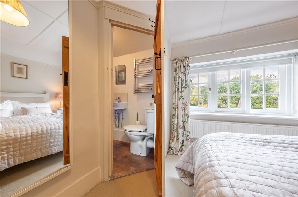 Bedroom one leading to the en-suite shower room at Densford Cottage, Amberley
