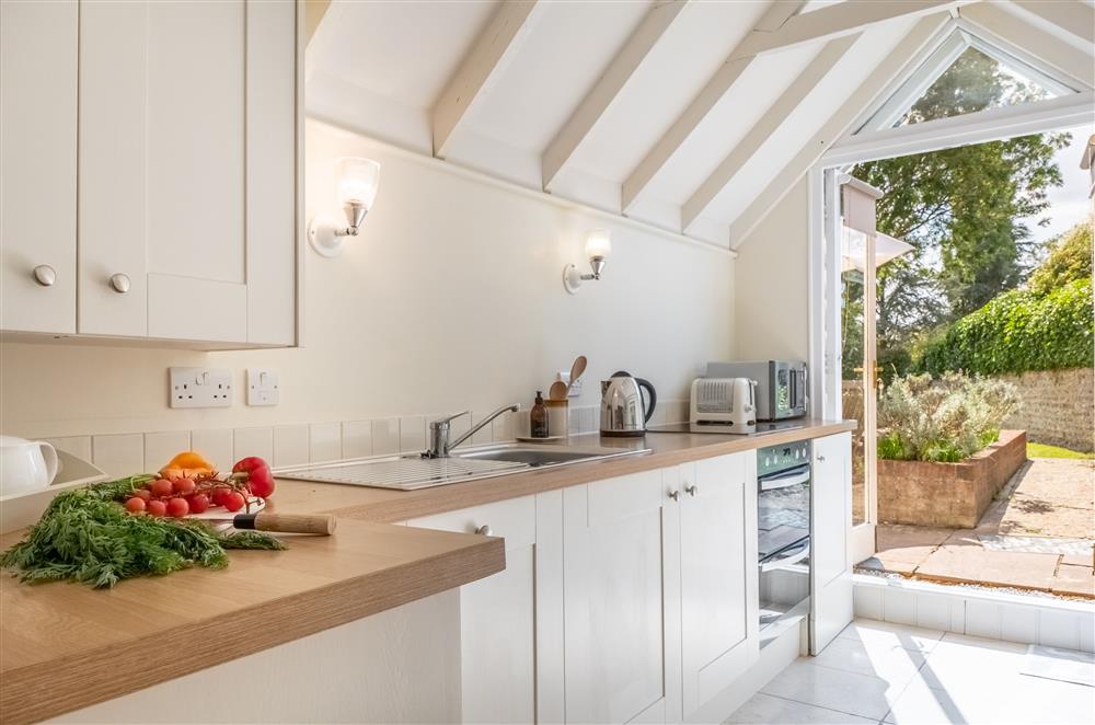 The bright and airy kitchen with french doors to the rear garden (photo 2) at Densford Cottage, Amberley