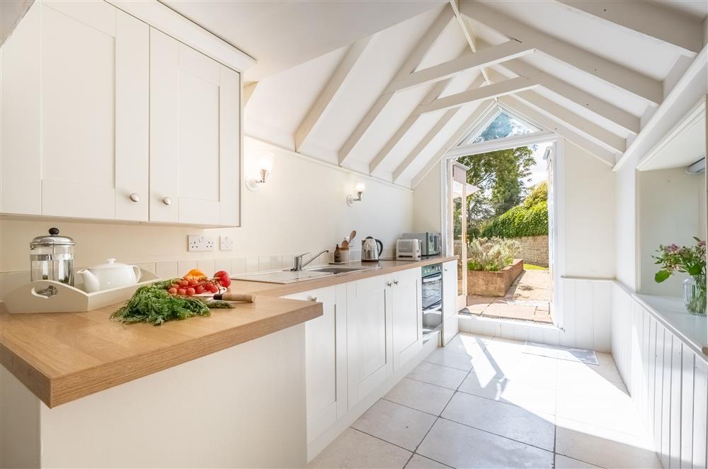 The bright and airy kitchen with french doors to the rear garden at Densford Cottage, Amberley