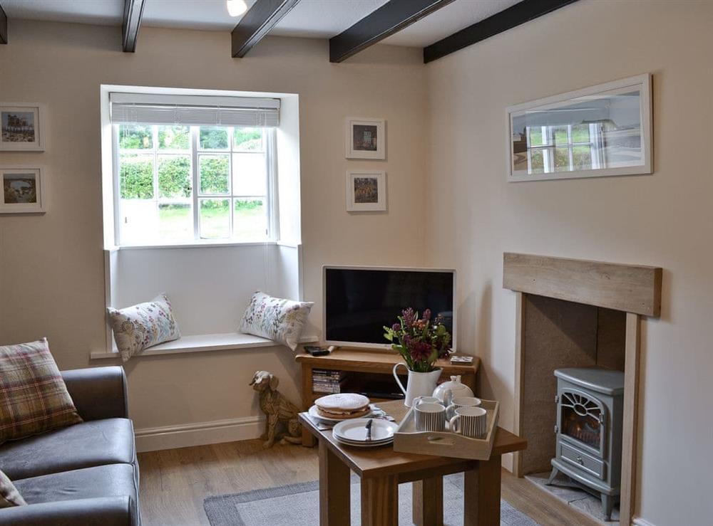 Cosy living room with wood beam ceiling at Derwent Cottage in Wrench Green, near Scarborough, North Yorkshire