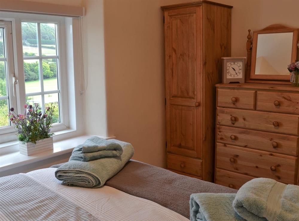 Double bedroom with great views through the window at Derwent Cottage in Wrench Green, near Scarborough, North Yorkshire
