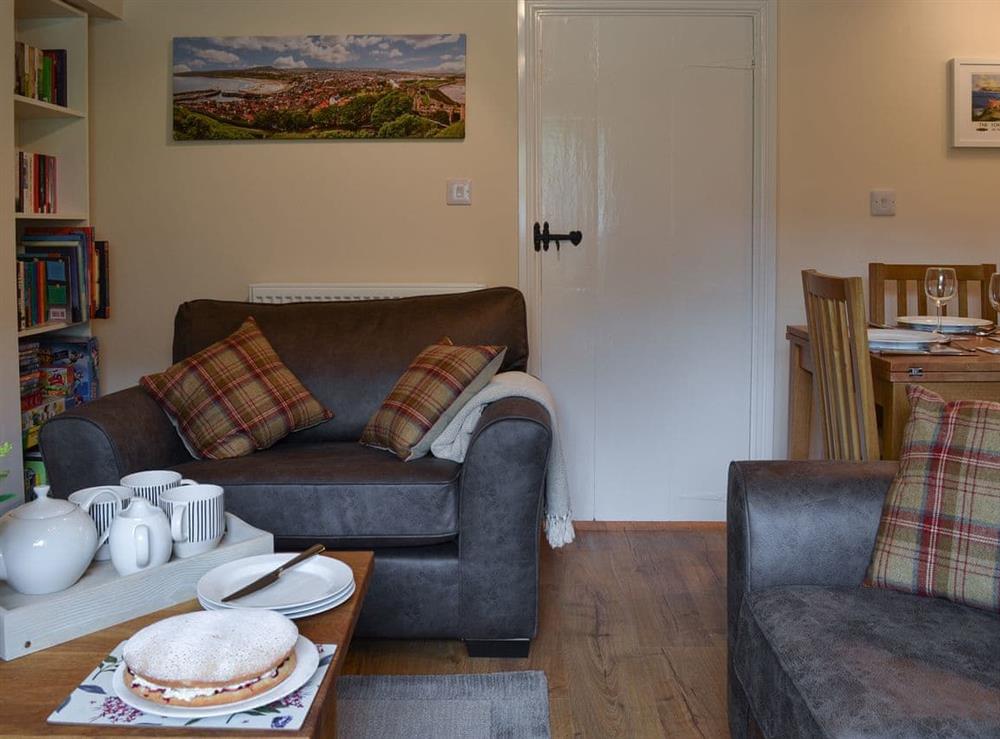 Living room with dining area at Derwent Cottage in Wrench Green, near Scarborough, North Yorkshire