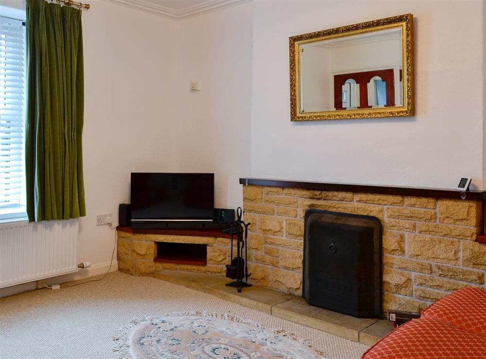 Relaxing living room with open fire at Derwent View in Setmurthy, near Bassenthwaite, Cumbria