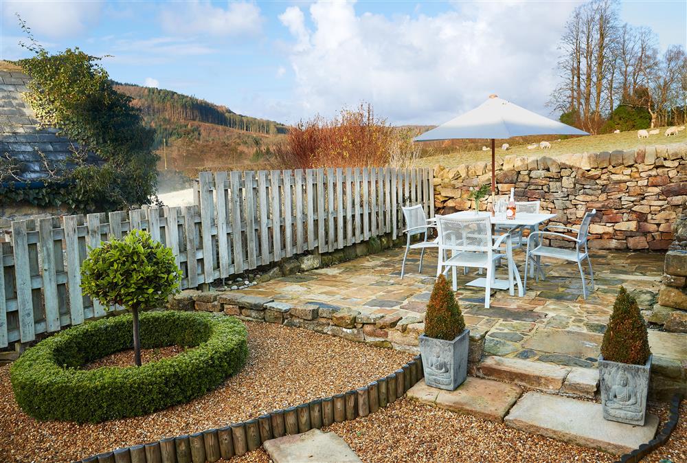 Enclosed rear garden with garden furniture, perfect for al fresco dining looking out over stunning views