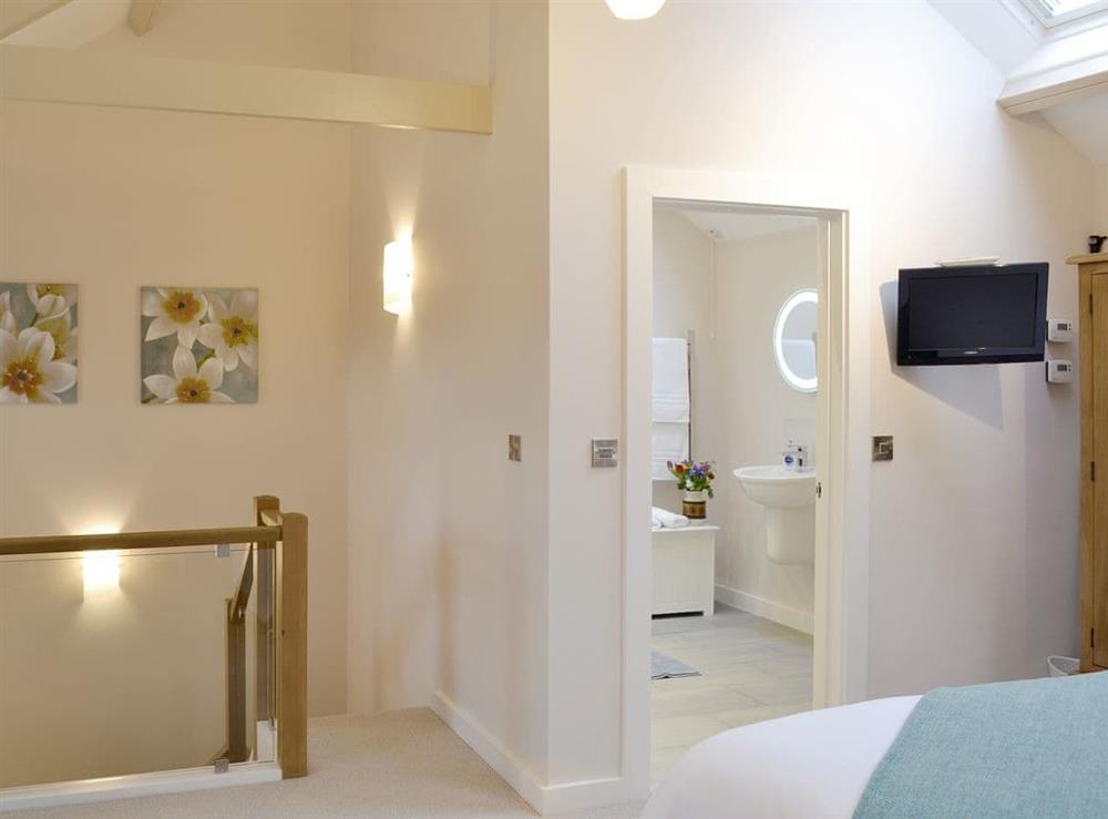 Double bedroom with en-suite shower room at Dew Cottage in St Buryan, near Sennen, Cornwall