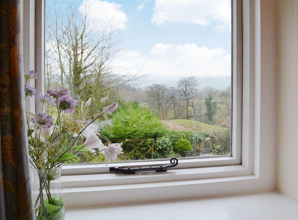 The rolling Derbyshire countryside and distant crags can be seen from the bedroom window at Dewsnaps Frost in Chinley, Nr Chapel-en-le-Frith., Derbyshire