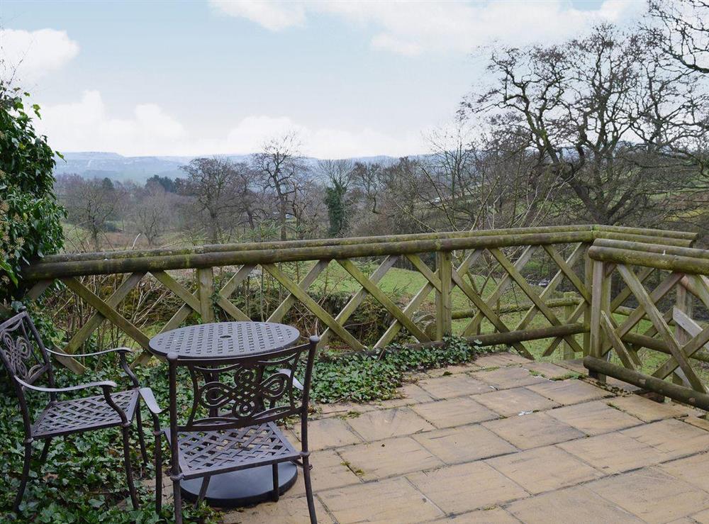 The flagged patio has seating and a table at which to sit and admire the far-reaching views at Dewsnaps Spring in Chinley, High Peak, Derbyshire., Great Britain