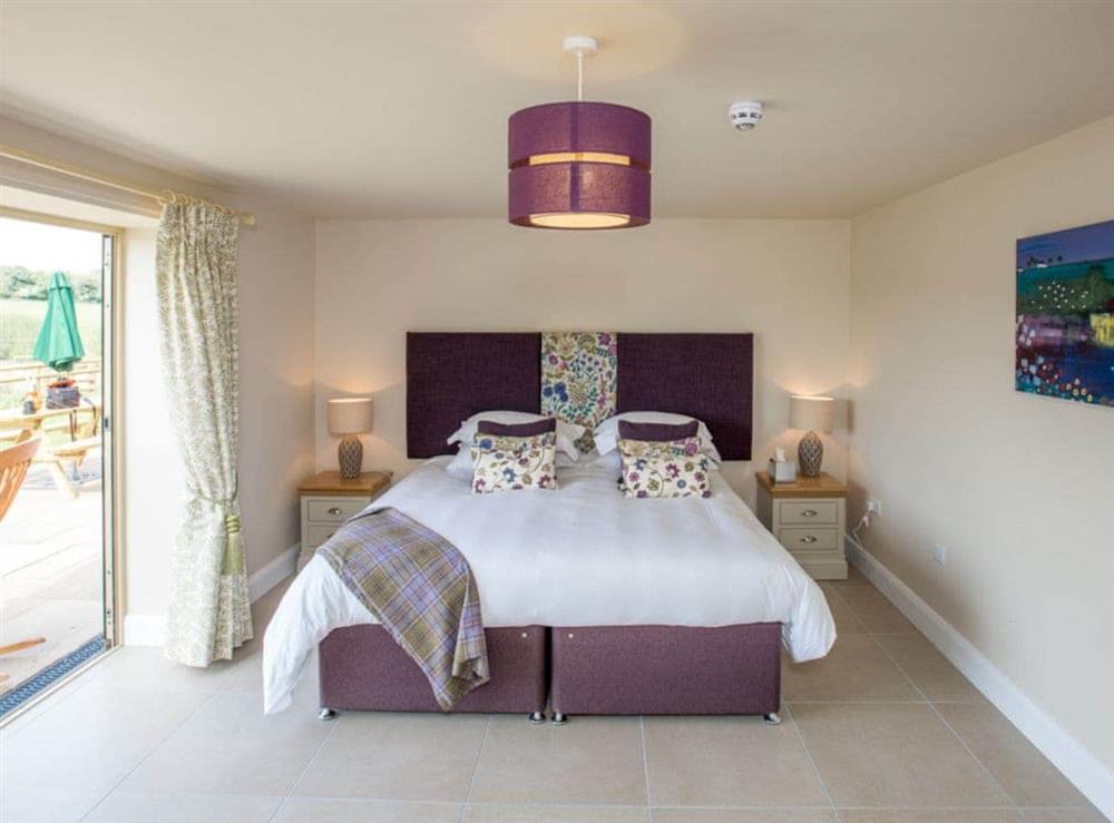 Ground floor double bedroom with doors to patio at The Rookery, 