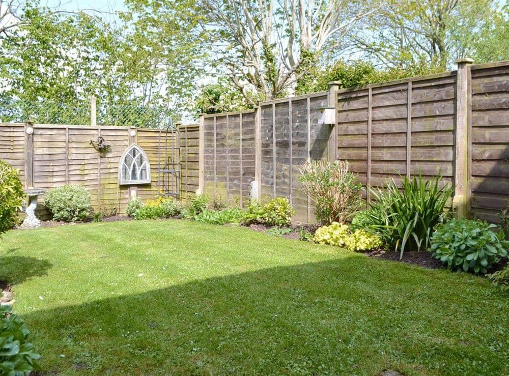 Attractive enclosed lawned garden at Dinsdale in Rustington, near Worthing, West Sussex