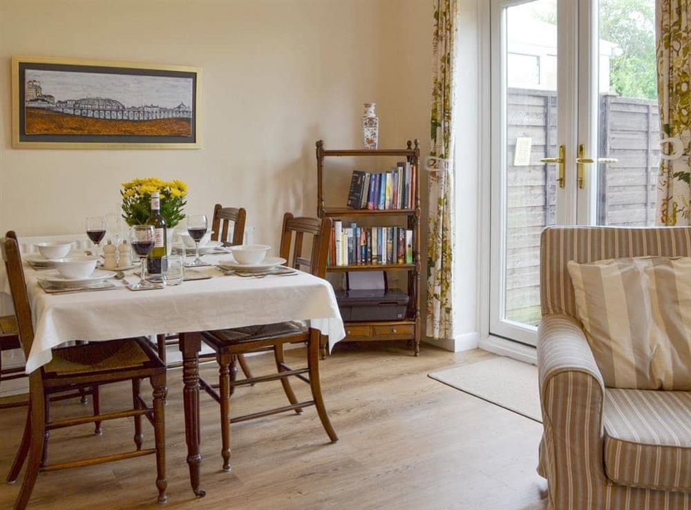 Light and airy dining area with French doors to garden at Dinsdale in Rustington, near Worthing, West Sussex