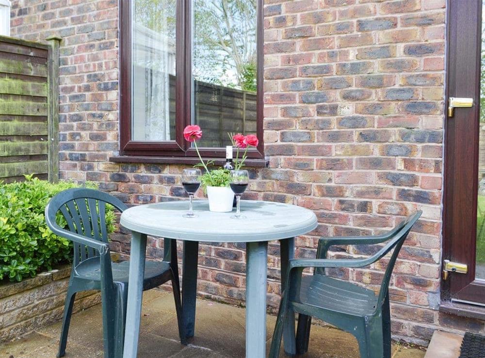 Patio area with outdoor furniture at Dinsdale in Rustington, near Worthing, West Sussex