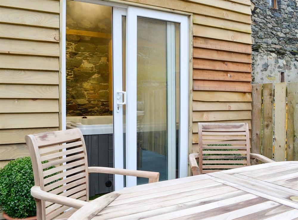 Outdoor area with table and chair, perfect for alfresco dining at Derwent Dale Cottage, 
