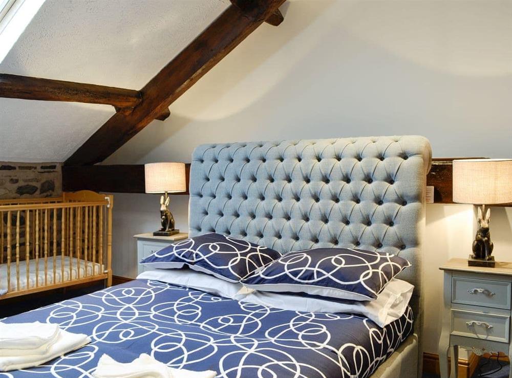 Relaxing first floor double bedroom with cot at Doddick Chase Cottage, 