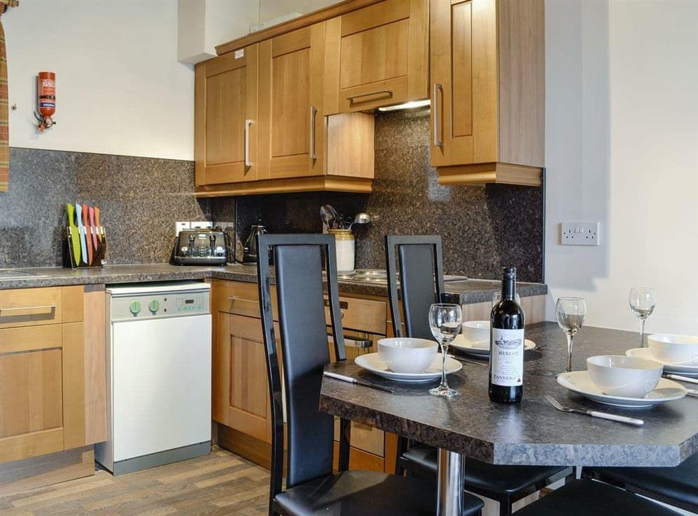 Well-equipped kitchen with dining area at Doddick Chase Cottage, 